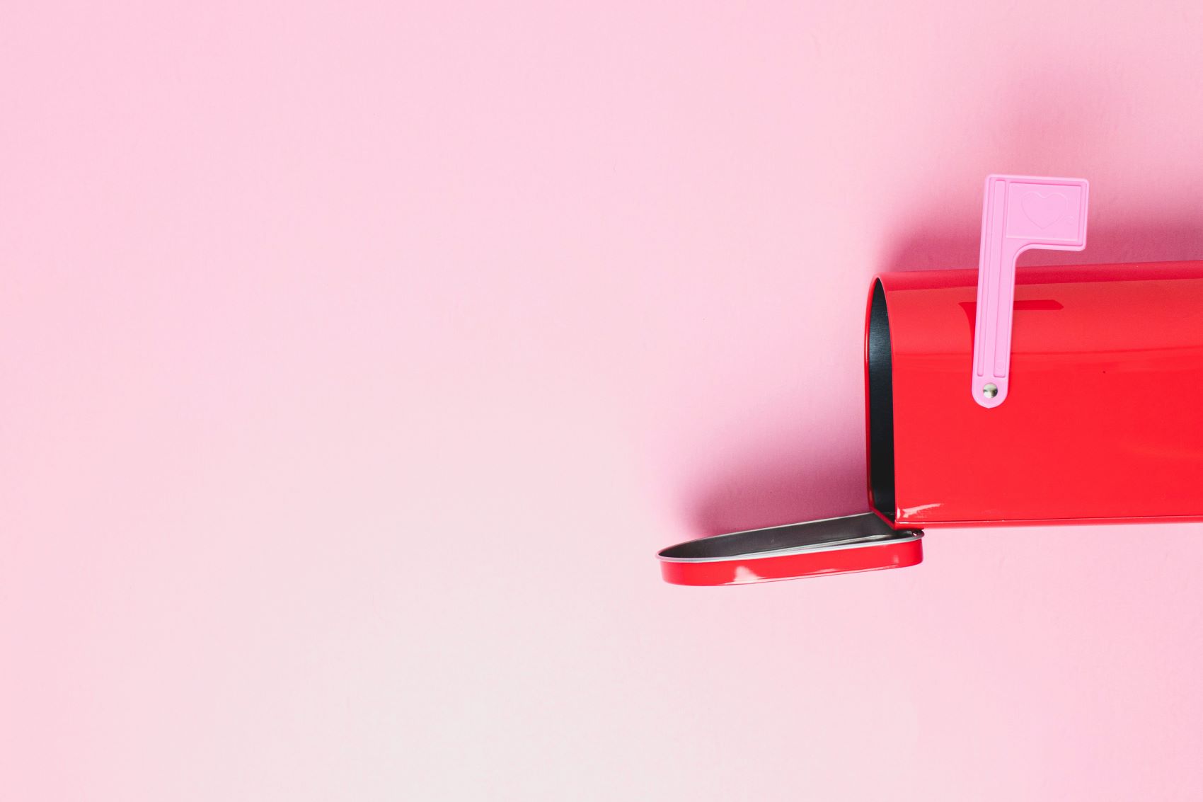 direct mail in a red mailbox with a pink background