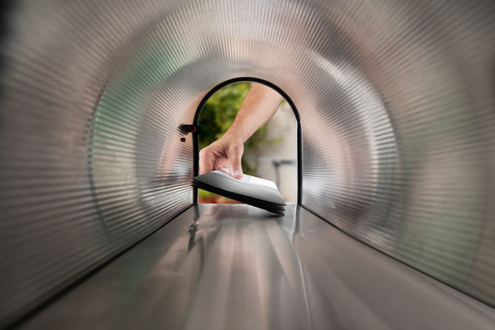 direct mail being delivered in a mailbox