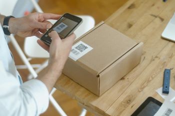 Woman scanning a QR code on direct mail