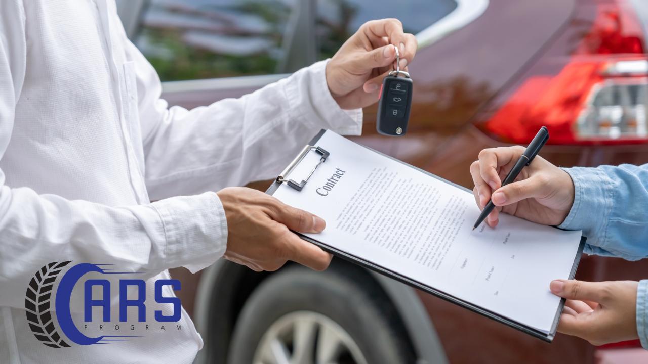 A car buyer signing a sales contract and receiving keys from a dealership representative during a vehicle delivery.